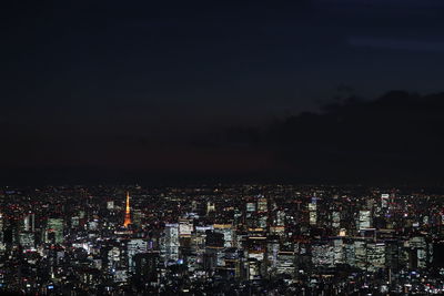 High angle view of illuminated cityscape against sky at night