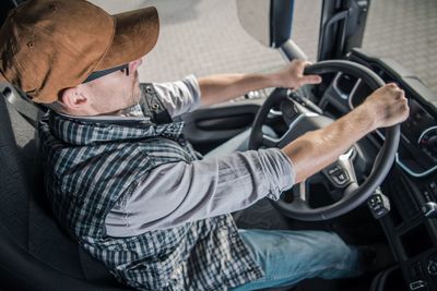 Midsection of man sitting in car