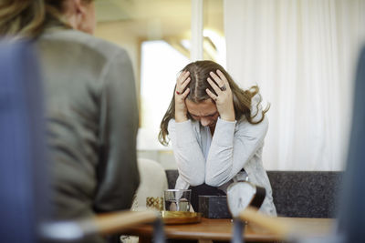 Displeased female patient discussing with therapist during session