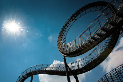 Low angle view of ferris wheel against blue sky