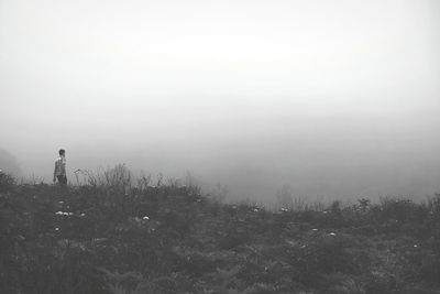 Scenic view of landscape against sky during foggy weather