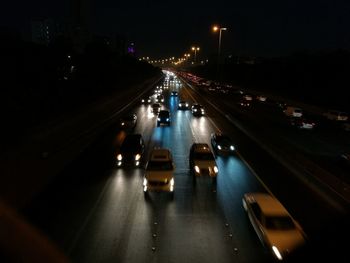 View of suspension bridge in city at night