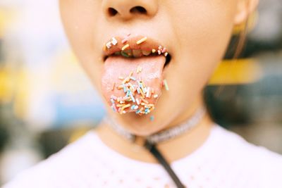 Close-up of young woman sticking out tongue