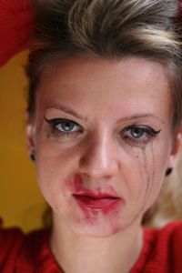 Close-up of woman with smudged make-up