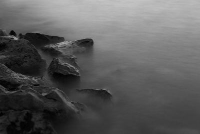 High angle view of rocks in sea against sky