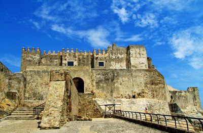 Low angle view of old castle against blue sky