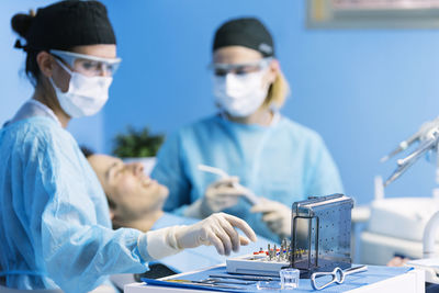 Dentists operating patient in medical clinic