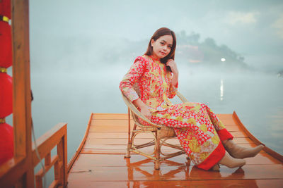 Asian woman wearing cheongsam traditional red dress on chinese new year travel.