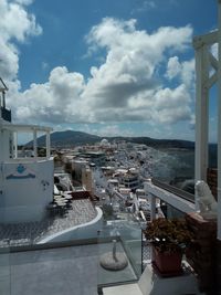 Buildings by sea against sky