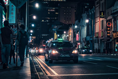 Illuminated city street and buildings at night