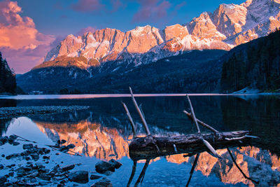 Scenic view of lake and mountains against sky during winter