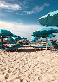 Umbrellas and lounge chairs on shore of beach