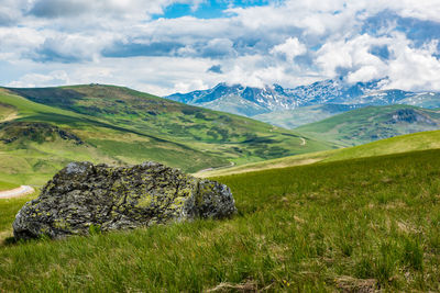 Scenic view of green landscape against sky