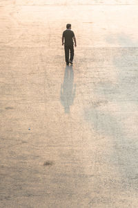 Full length of woman standing by railing