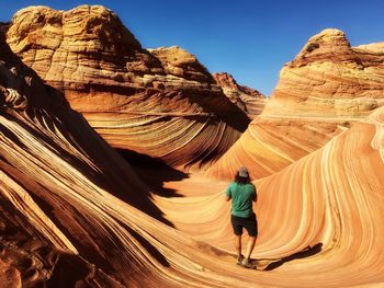 Rear view of man walking in desert