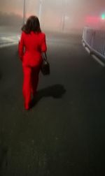 Rear view of woman walking in city at night