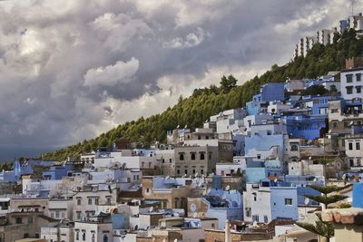 Residential buildings against cloudy sky