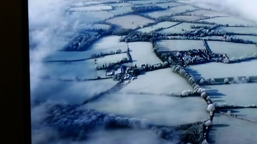 Close-up of snow covered landscape against sky