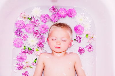 Portrait of woman holding pink flower