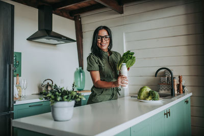 Young woman smiling while standing at home