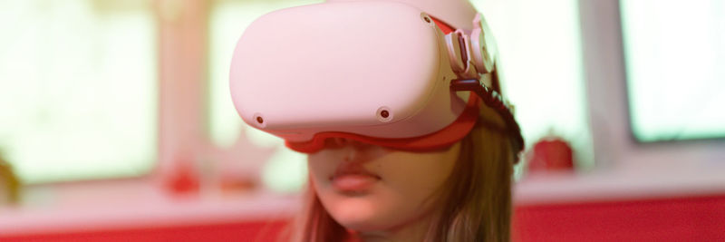 Vr game and virtual reality. kid girl gamer fun playing on futuristic simulation video shooting game