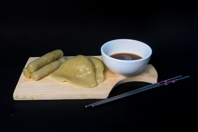 Close-up of ice cream on table against black background