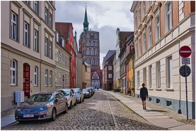 Street amidst buildings in city against sky