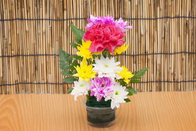 Close-up of pink flower vase on table