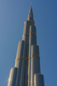 Low angle view of modern building against blue sky