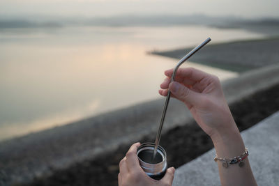 Midsection of woman holding umbrella