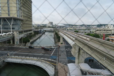 Aerial view of bridge over highway against sky