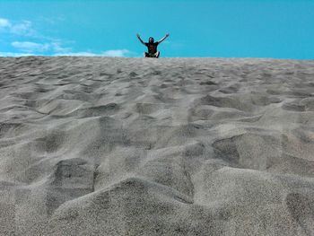 Full length of man on sand at beach against sky