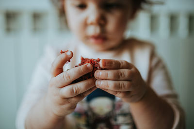 Close-up of child holding cake