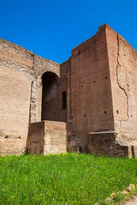 Low angle view of historical building against blue sky