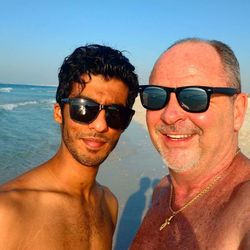 Portrait of smiling man wearing sunglasses against sky