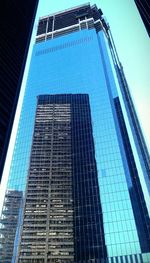 Low angle view of modern building against clear blue sky