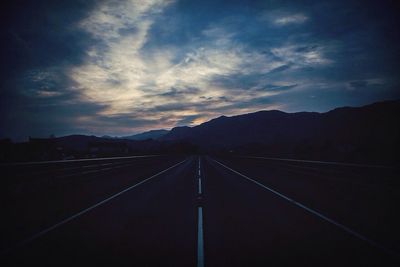 Empty road against sky at night