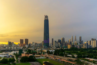 View of buildings in city at sunset