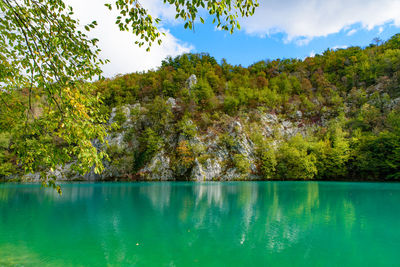 Scenic view of swimming pool by lake against sky