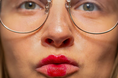 Close-up portrait of woman with red lipstick