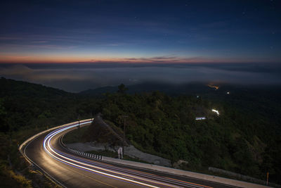 High angle view of light trails on road at night