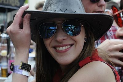 Portrait of smiling young woman wearing sunglasses