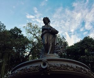 Low angle view of statue against sky in park