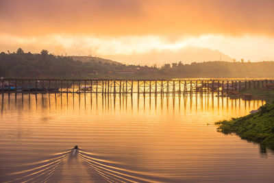 Scenic view of lake against orange sky