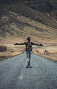 Man skateboarding on highway