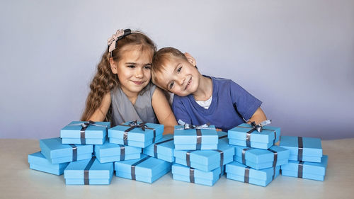 Portrait of smiling mother and daughter against white background