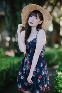 Young woman wearing hat standing outdoors