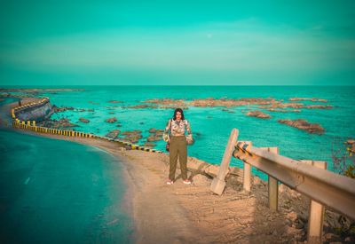 Woman on beach against sky