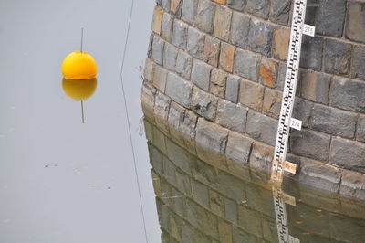 High angle view of yellow balloon on wall