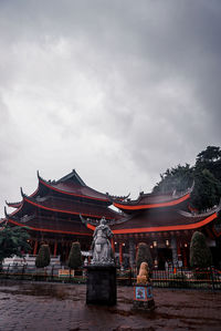 People outside temple against building